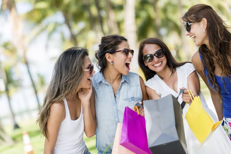 Group of girls having fun shopping for the summer